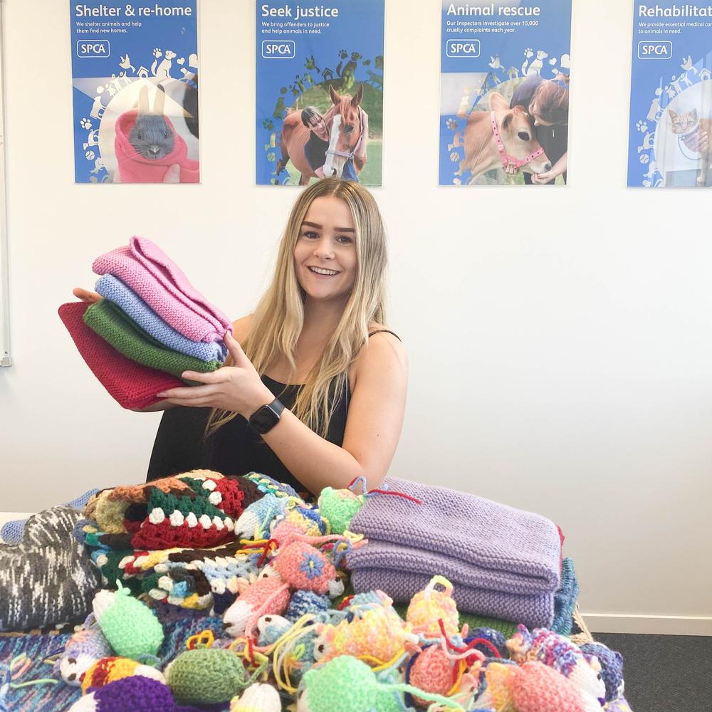 Alyssa receiving amazing handmade blankets and mice donated for SPCA animals