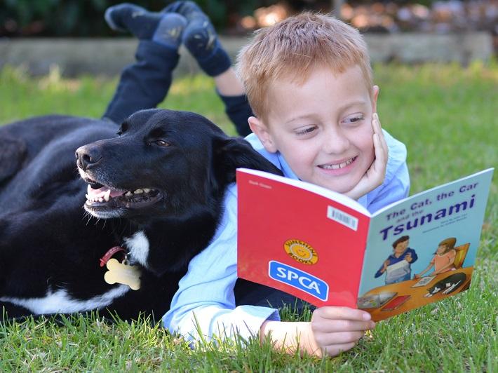 SPCA education storybooks, child reading to dog